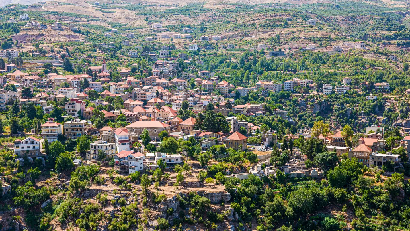 Aerial view of a mountain village with red-tiled roofs